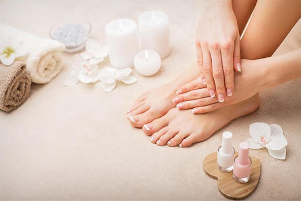 Close-up of manicured feet and hands at a spa